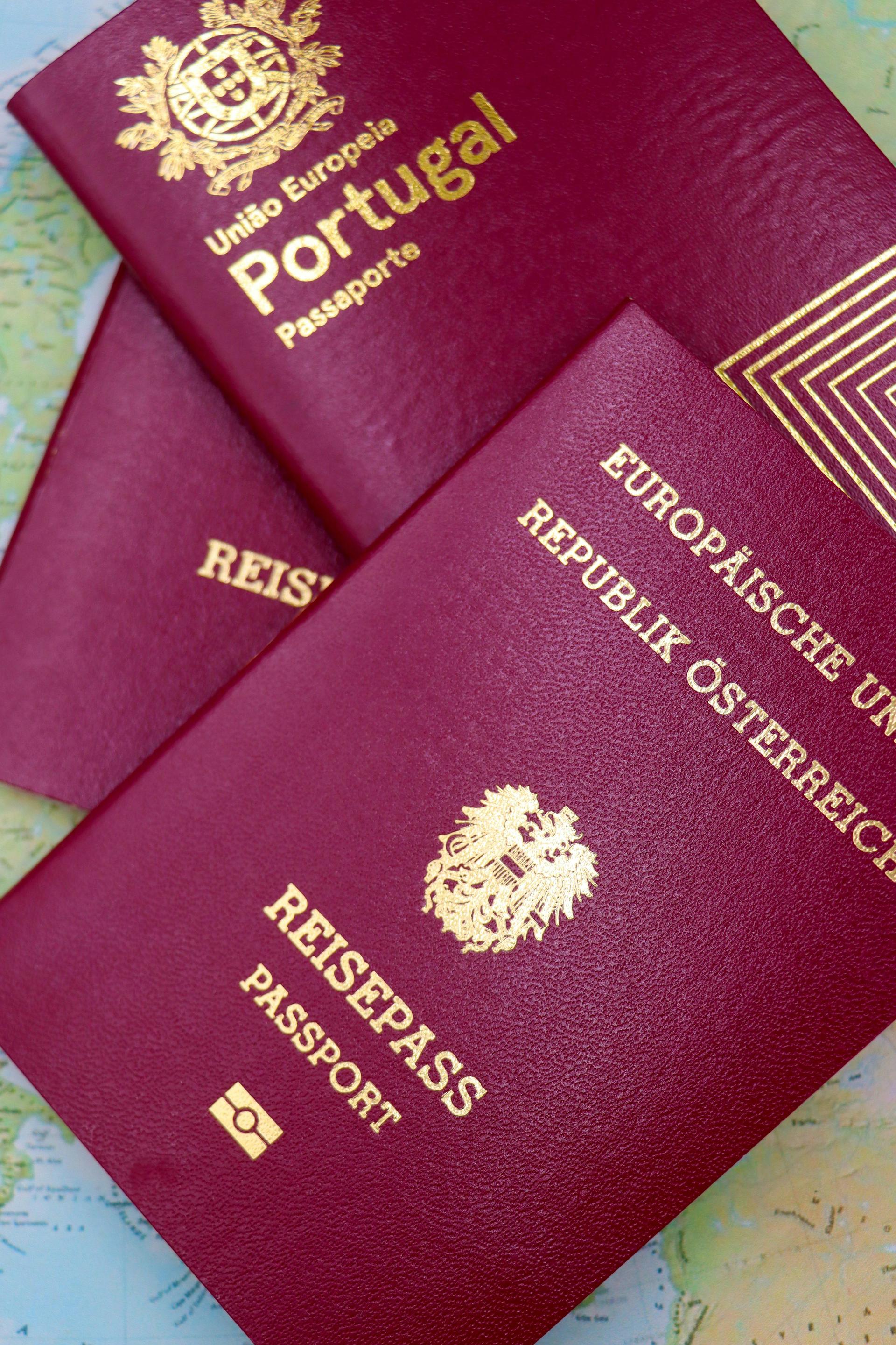 Passports resting on a world map, symbolising international travel and dual belonging between two countries.