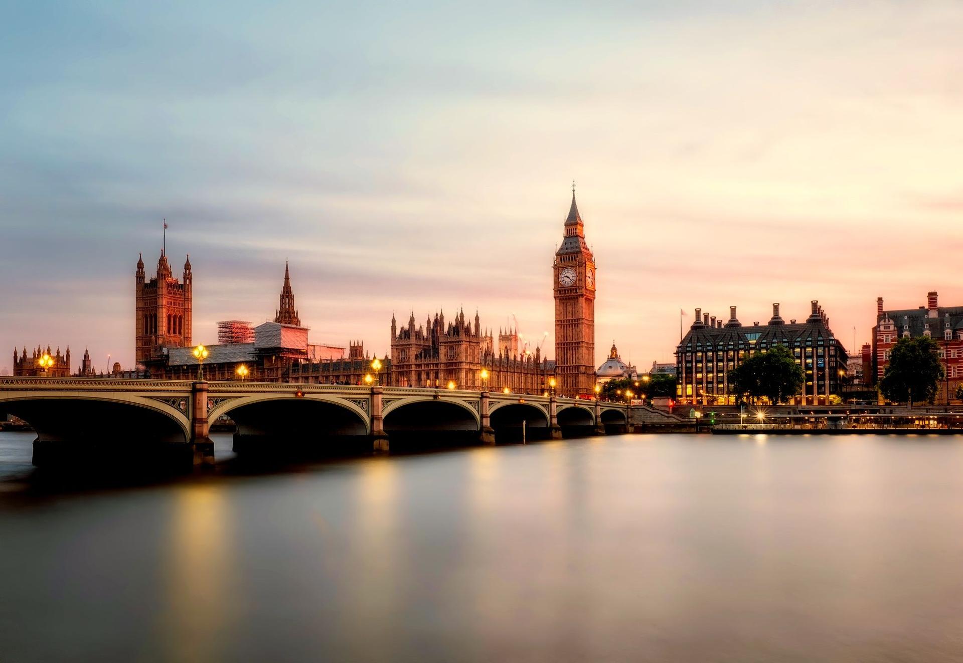 Big Ben and the Houses of Parliament across Westminster Bridge at sunset, the seat of the British legislation behind the new refugee rules.