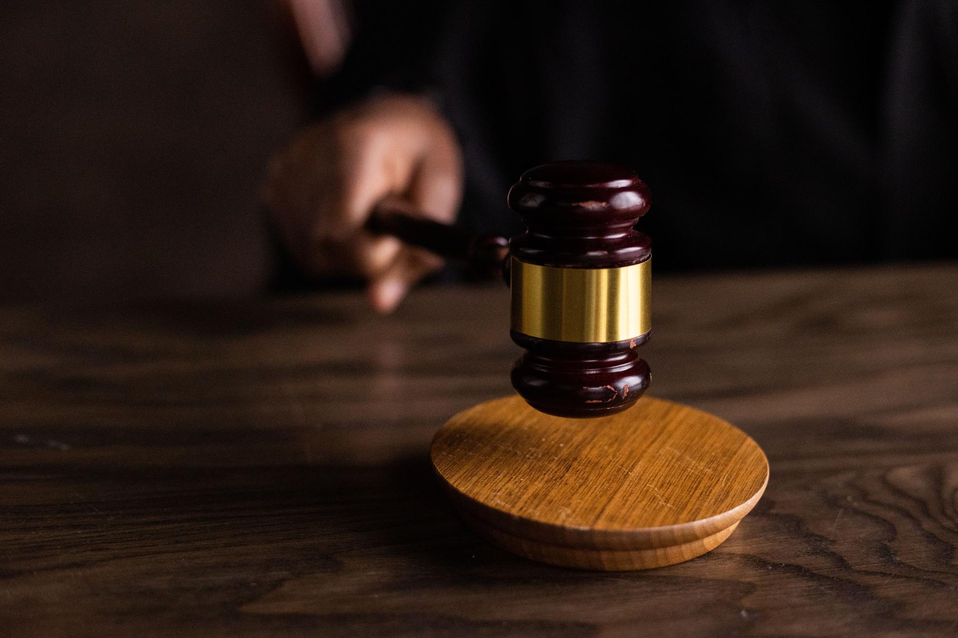 A wooden gavel striking a sound block, symbolising a court ruling on land ownership