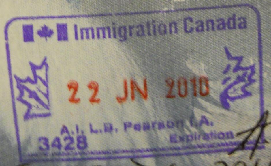 A Canadian passport page bearing an immigration entry stamp, symbolising citizenship and border documentation.