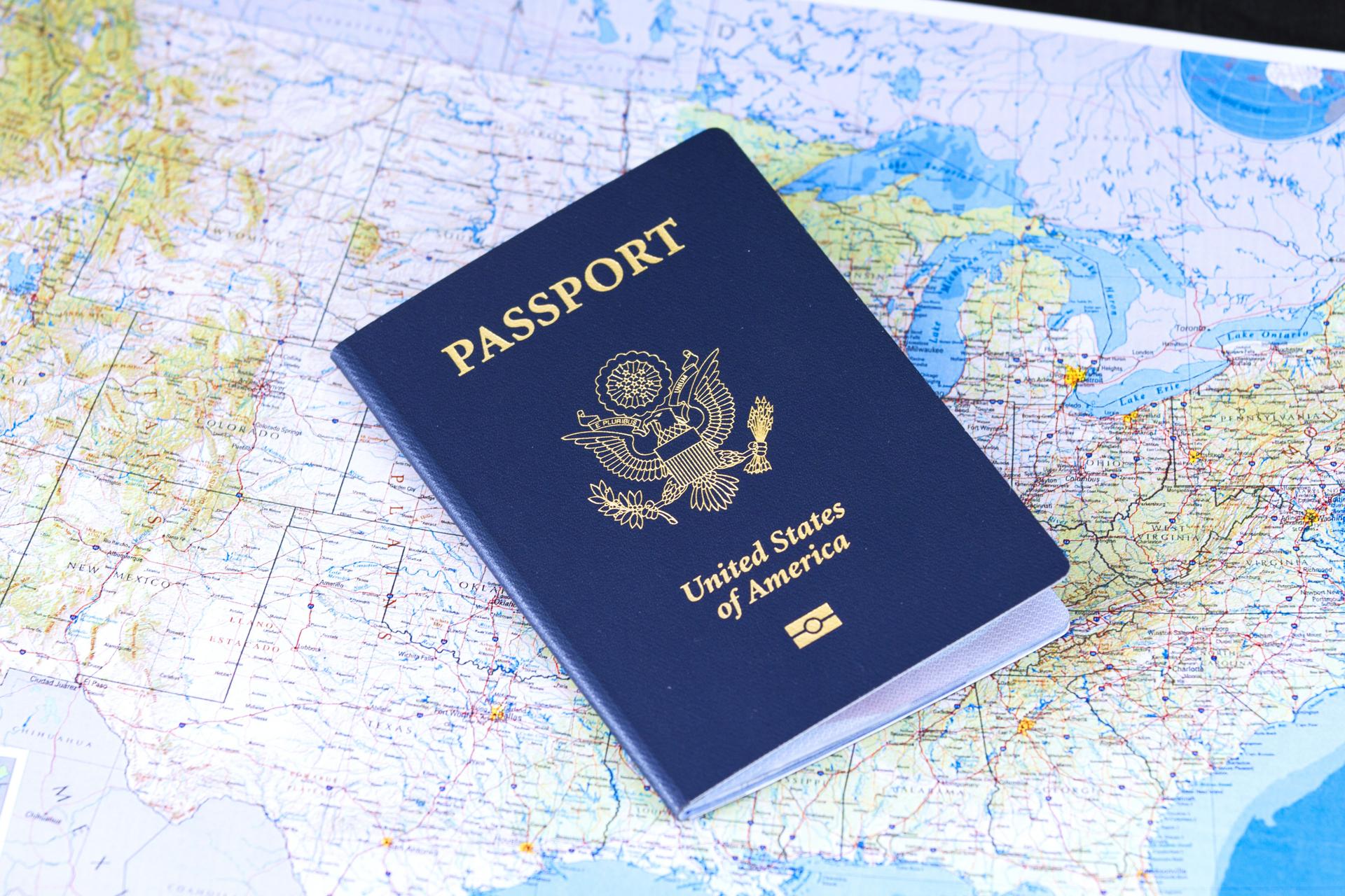 A United States passport resting on a world map, symbolising visa and immigration decisions