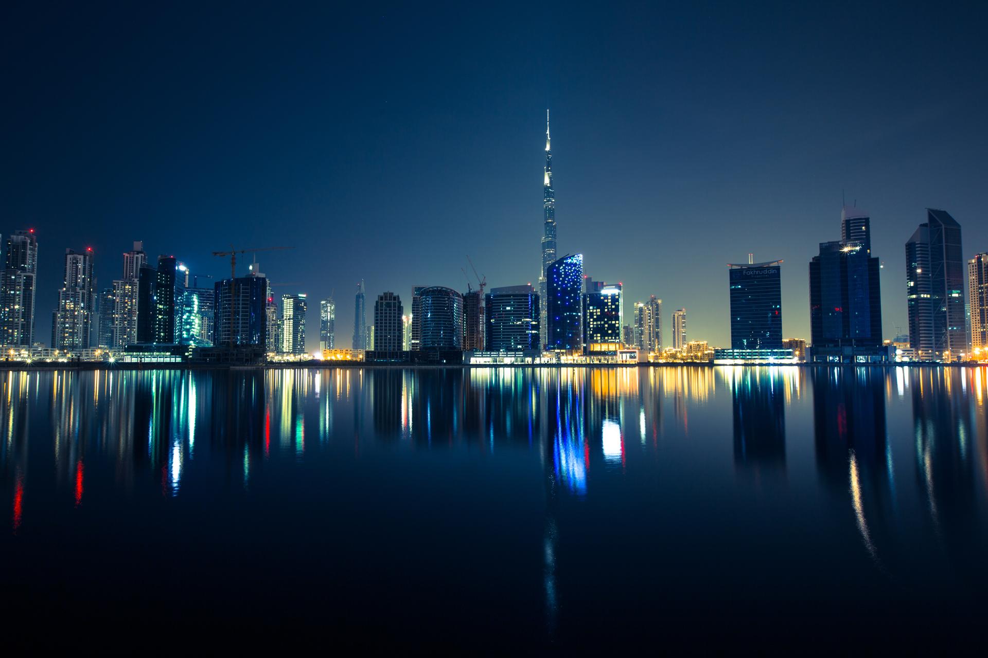 The Dubai skyline at dusk, with the Burj Khalifa rising above the city's towers