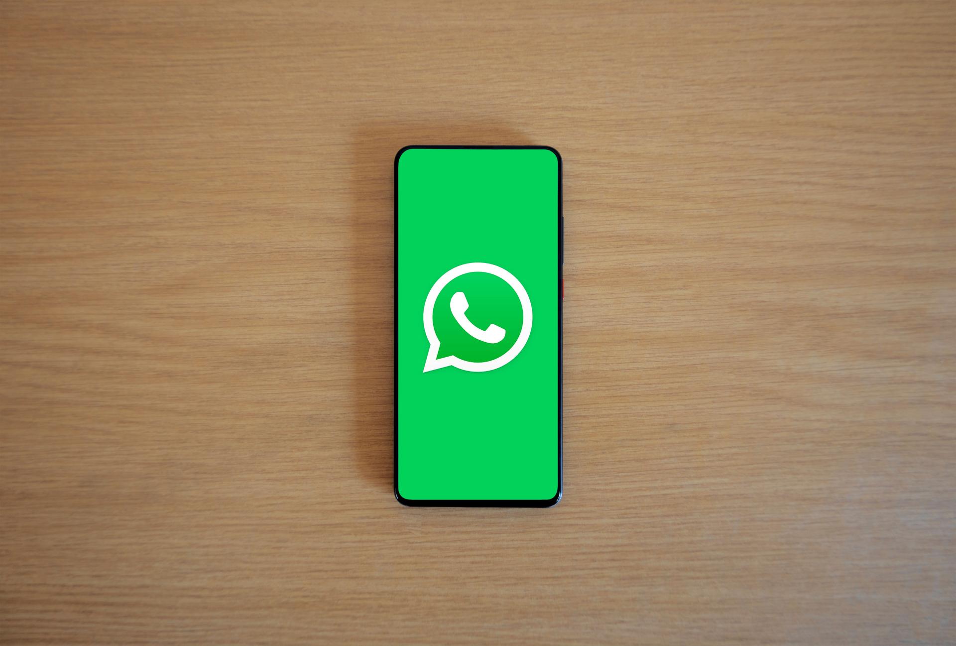 A smartphone screen displaying the WhatsApp logo, the messaging app used daily by Kenyans living abroad