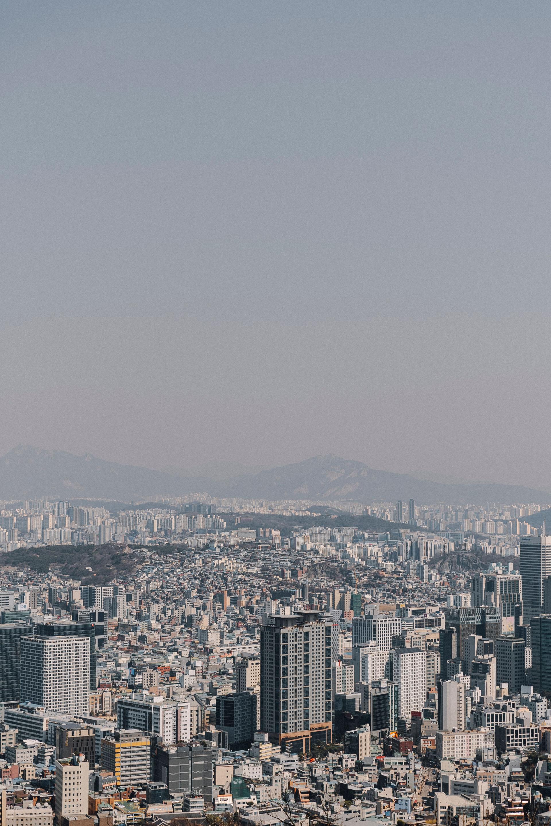 Aerial view of the Seoul skyline at dusk, with modern high-rise towers under a clear sky in South Korea's capital