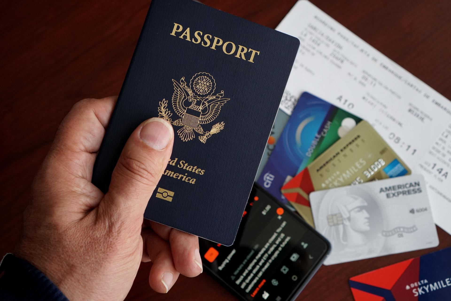 A United States passport photographed up close alongside travel documents, symbolising the cost of naturalisation