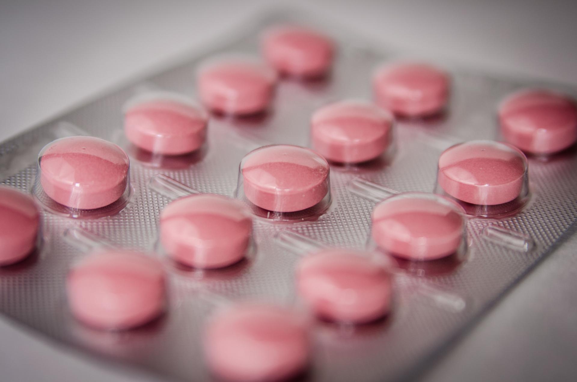 Close-up of assorted round medication tablets and pills, illustrating oral drug treatment