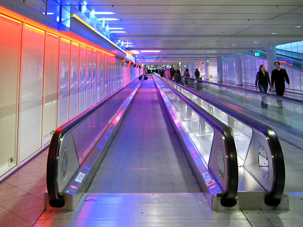 Travellers move through the bright departures terminal at Munich Airport, a major German arrival gateway for skilled foreign workers.