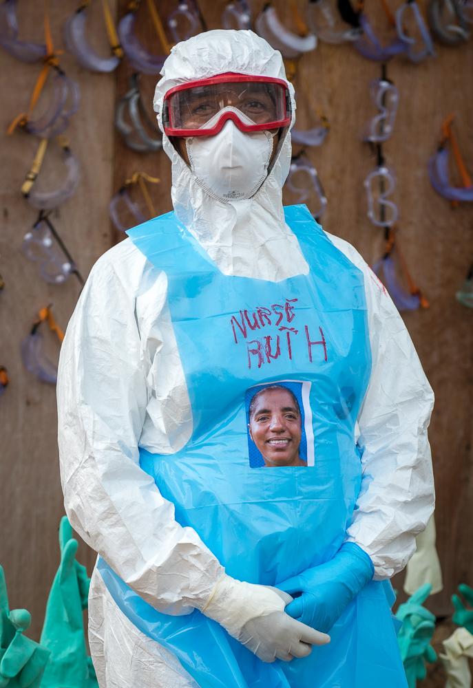 A nurse in full personal protective equipment at an Ebola treatment unit, illustrating the kind of high-consequence isolation care now being planned for a US facility in Kenya.