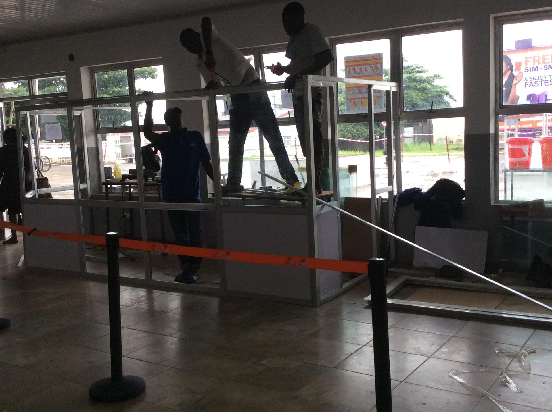 A health screening room set up at an international airport during an Ebola outbreak, with information posters