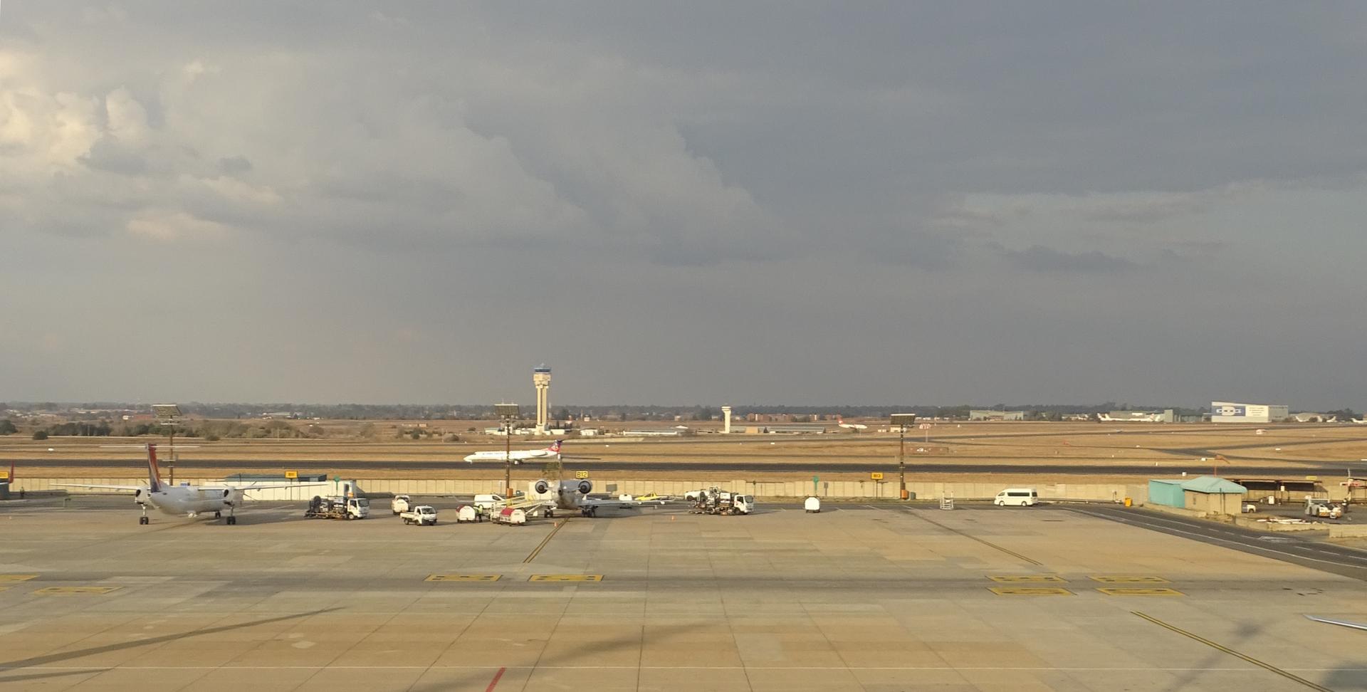 Travellers and aircraft at O.R. Tambo International Airport in Johannesburg, South Africa's main international gateway.