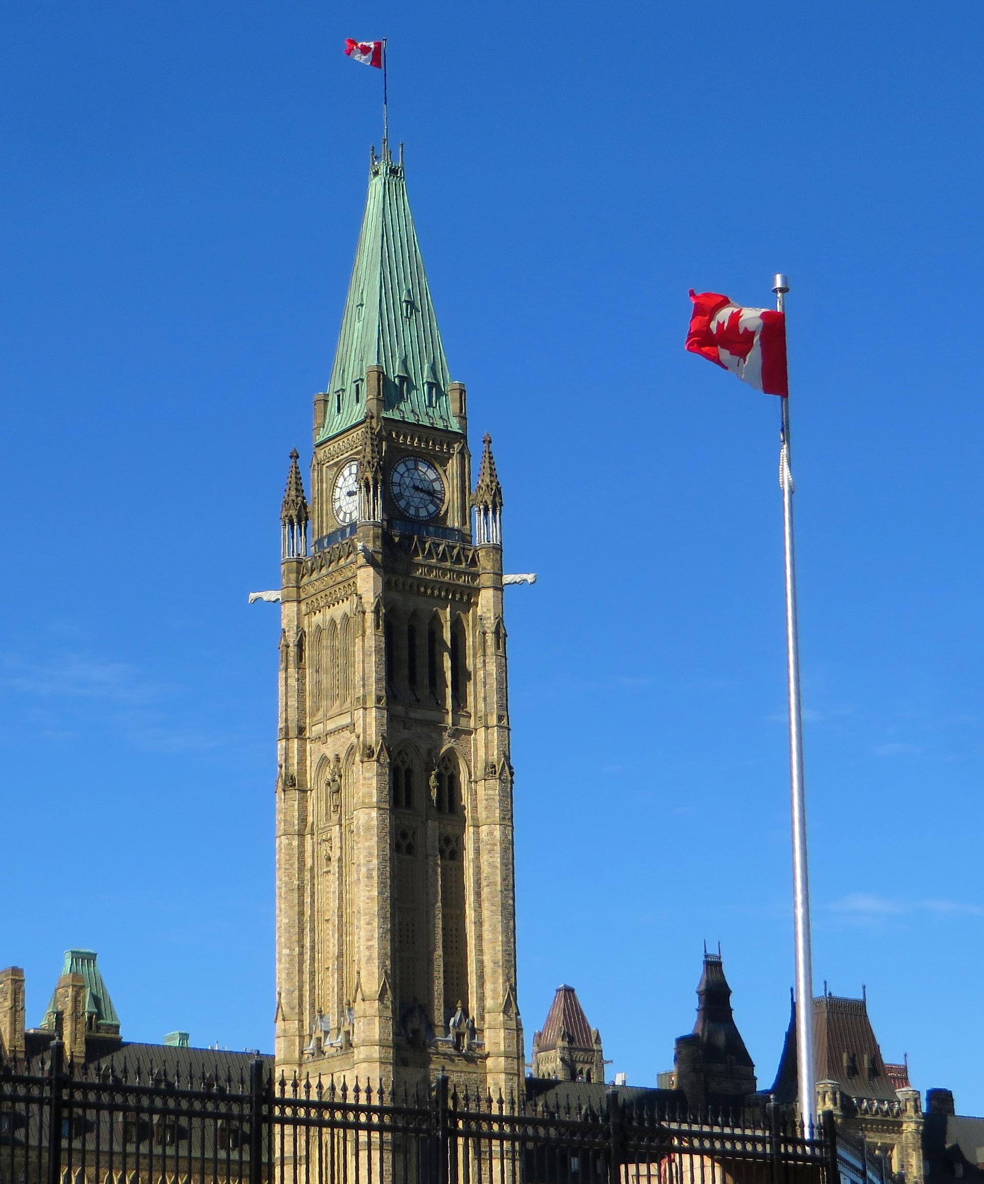Canada's flag flies above the Centre Block and Peace Tower on Parliament Hill in Ottawa, Ontario.