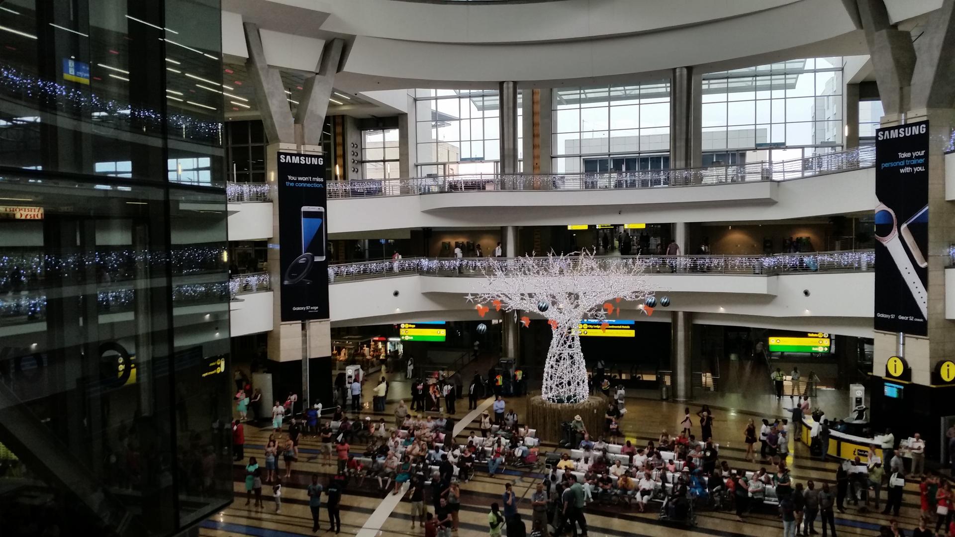 Travellers move through the arrivals hall at O.R. Tambo International Airport in Johannesburg, South Africa.