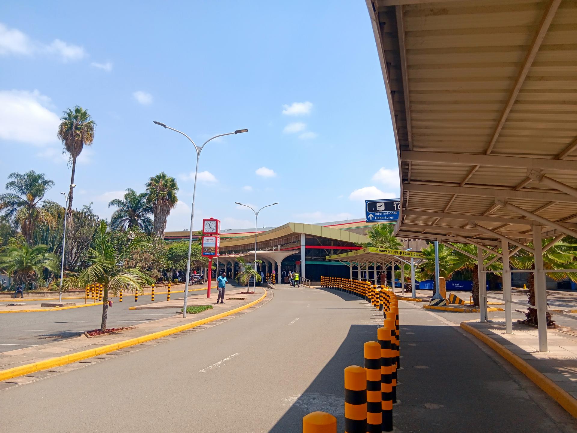 The landside terminal building at Jomo Kenyatta International Airport in Nairobi, Kenya, under a bright blue sky