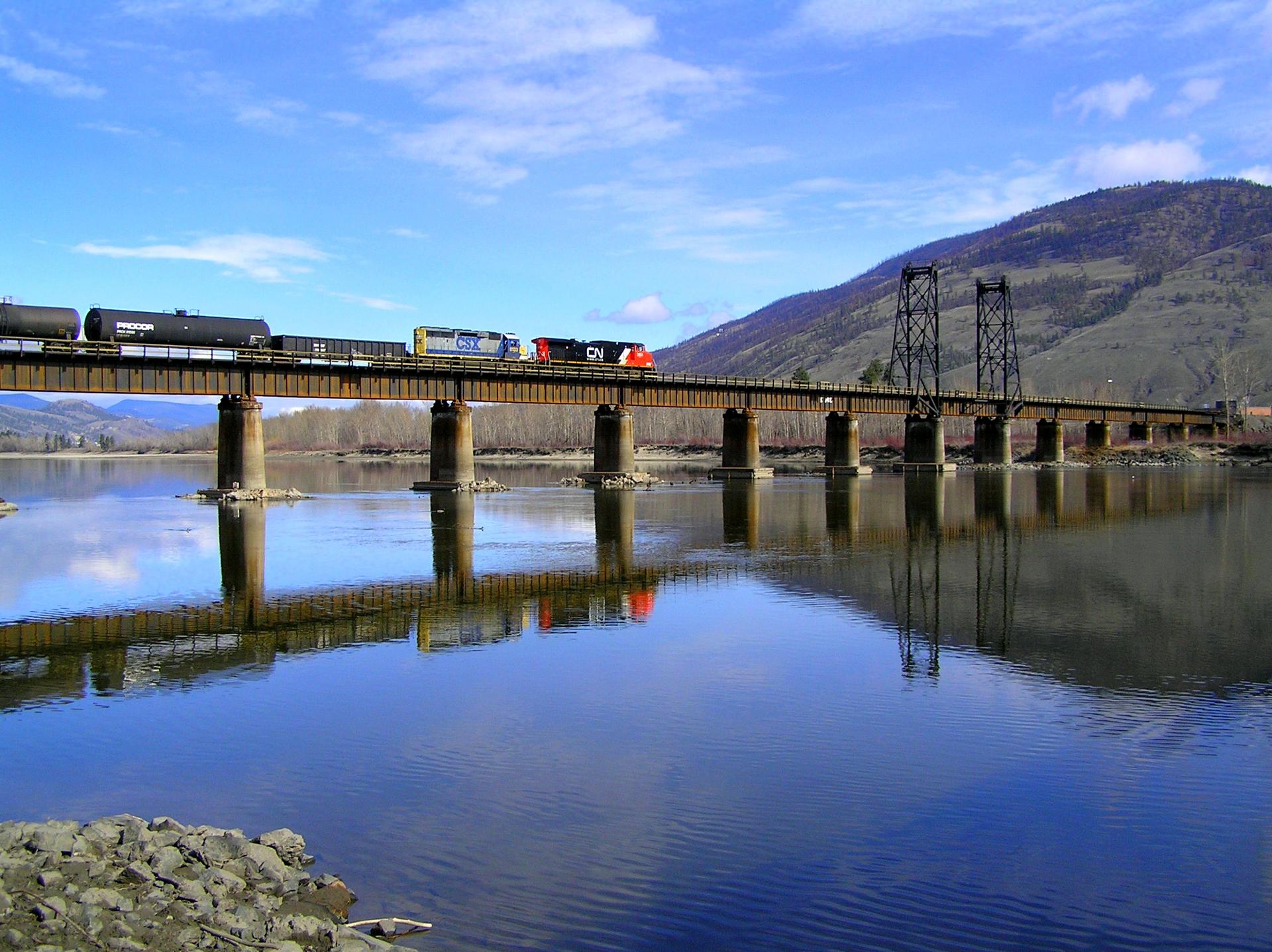 View of the North Thompson River near Kamloops, British Columbia, with the CN Railway bridge crossing the wide, fast-moving waters of the river