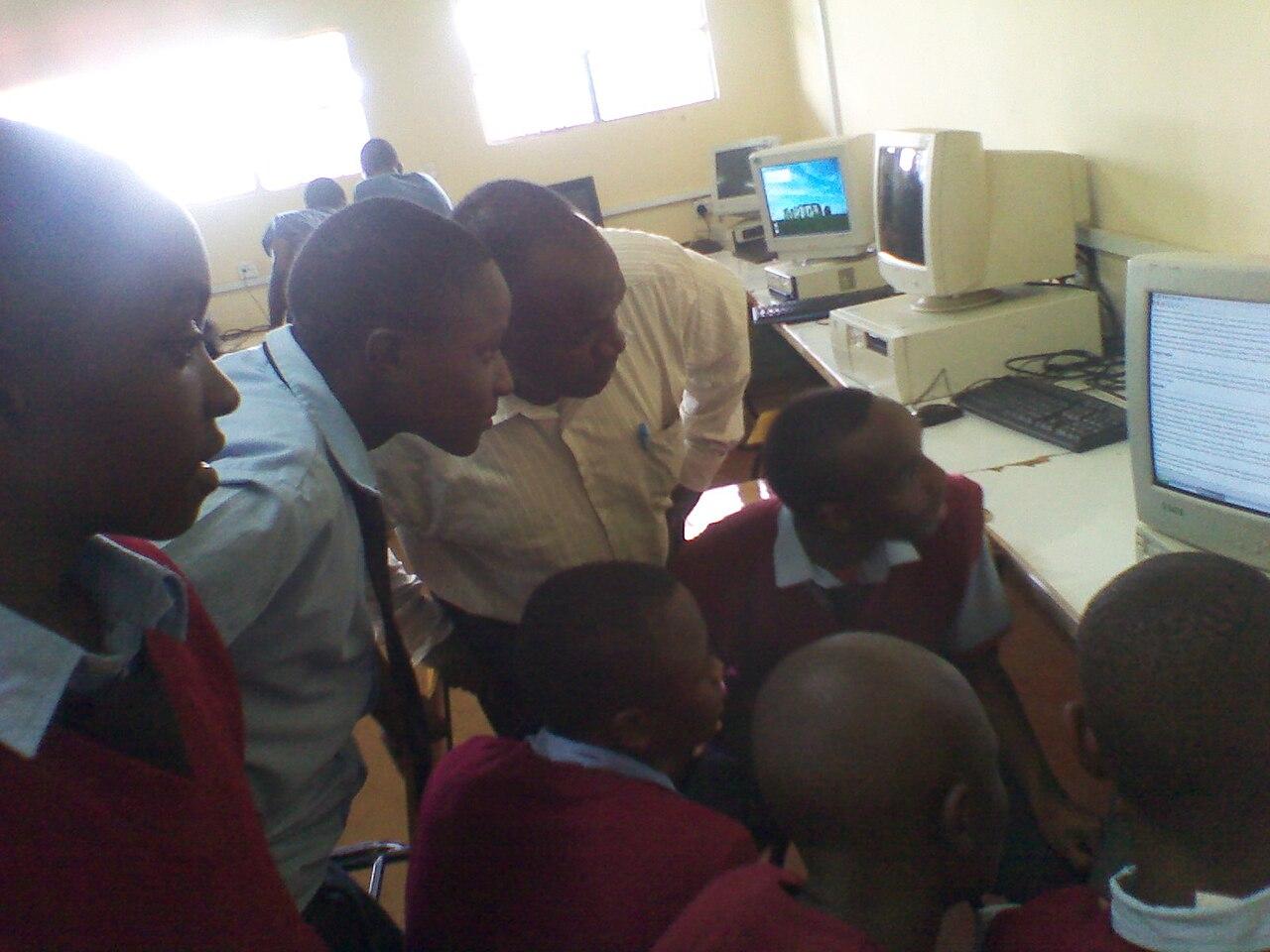 Students in uniform seated at desks inside a classroom at a Kenyan boys' high school