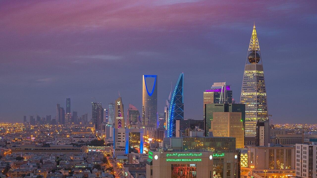 The skyline of Riyadh, Saudi Arabia, with the Kingdom Centre tower rising above the city at dusk