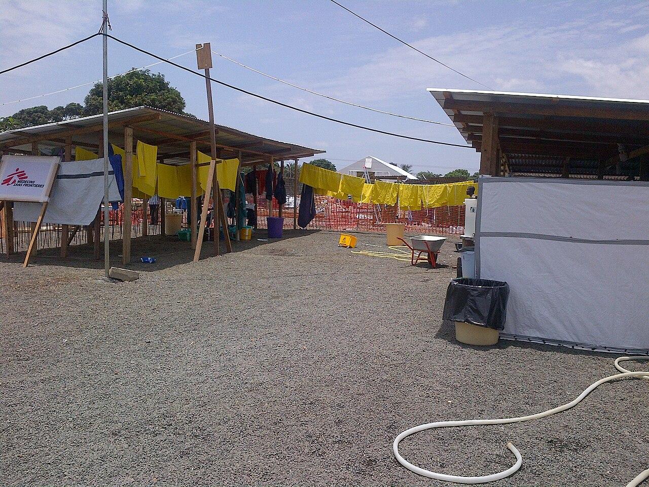 Health workers in protective gear outside an Ebola treatment unit in Central Africa