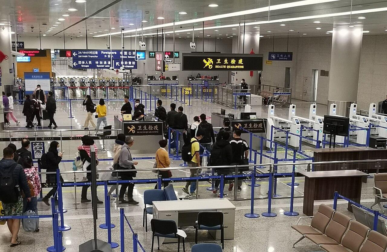 Health officials screen arriving air passengers for fever using thermal cameras at an international airport terminal.