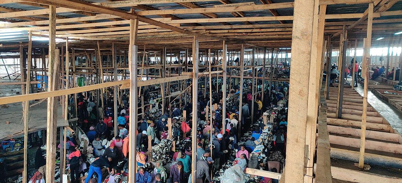 Rows of secondhand shoes displayed for sale at an open-air Kenyan market