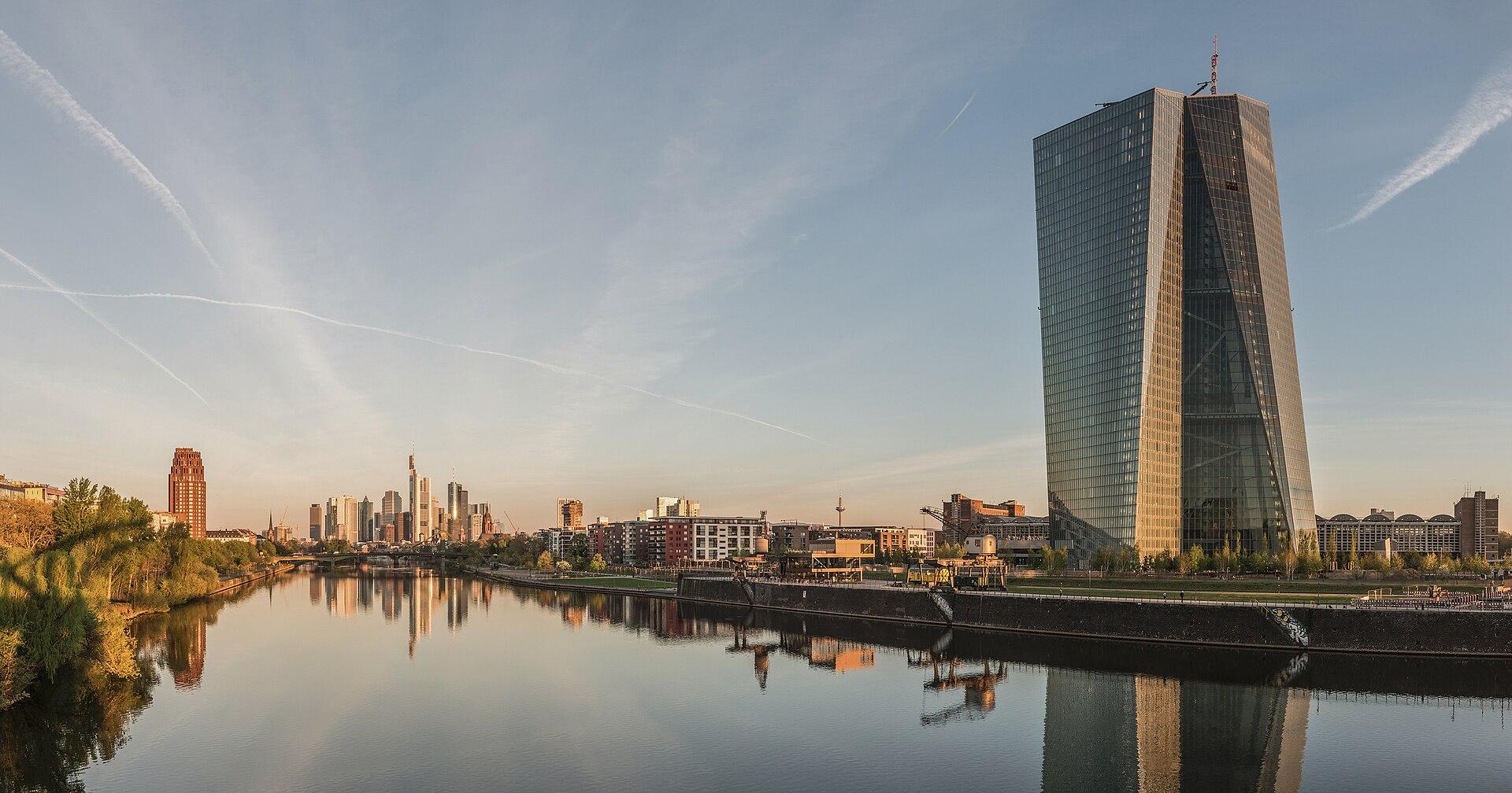 The European Central Bank tower and Frankfurt skyline at dawn, seen across the River Main