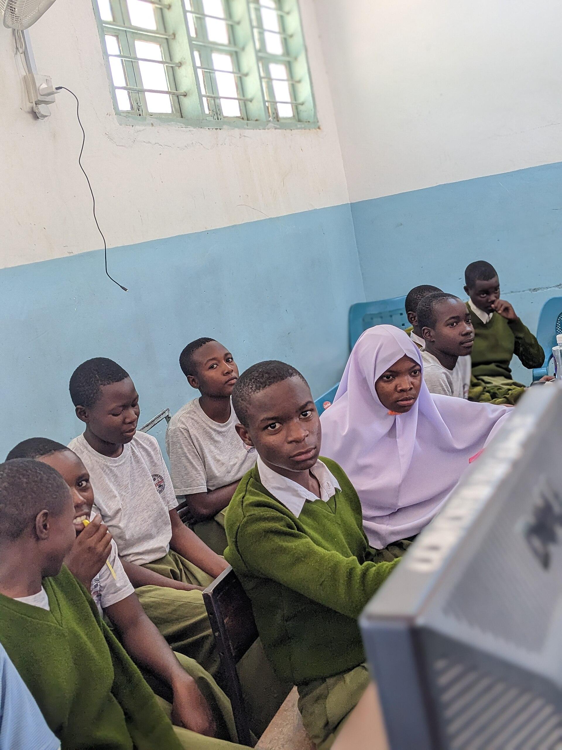African secondary school students working together at desktop computers in a school computer laboratory