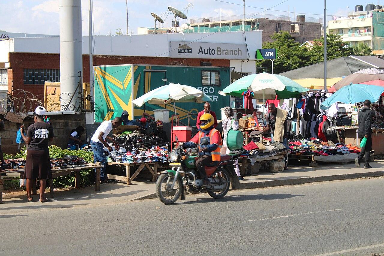 A boda boda motorcycle rider waits for passengers on a street in Nairobi, Kenya