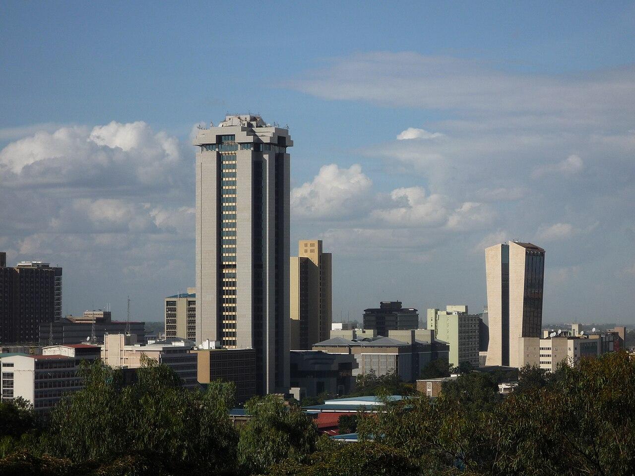 The Nairobi city skyline with high-rise office towers under a bright sky, symbolising Kenya's commercial heart.