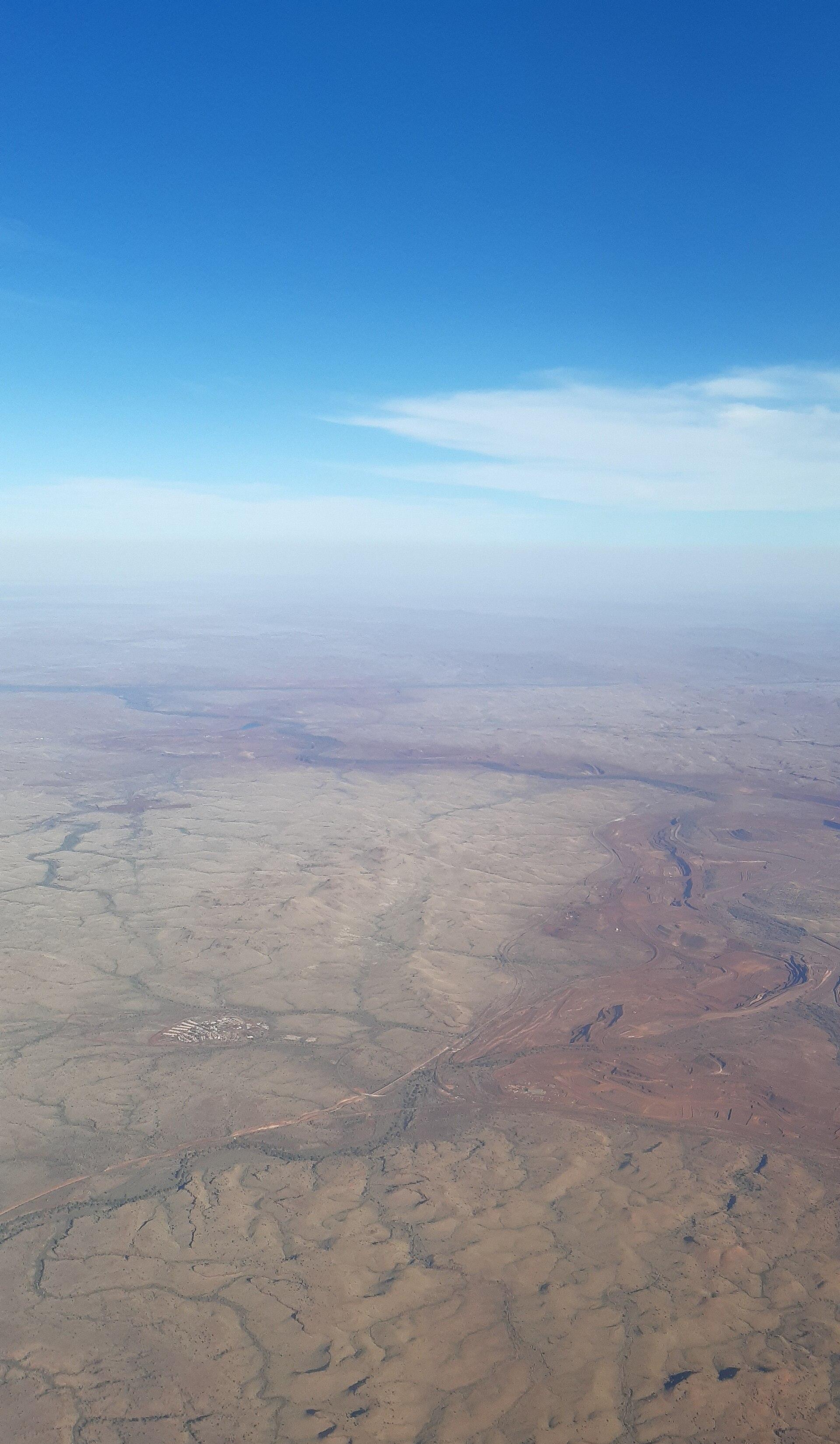 Aerial view of an iron ore mine cut into the red earth of Western Australia's Pilbara region
