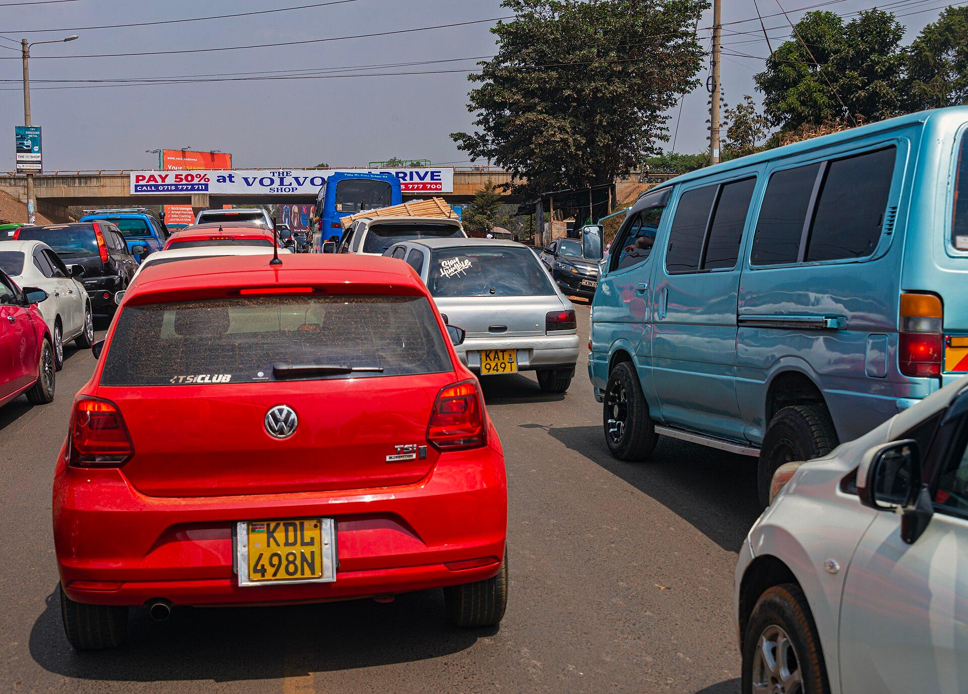 Heavy traffic backed up along a Nairobi road, matatus and cars queuing bumper to bumper