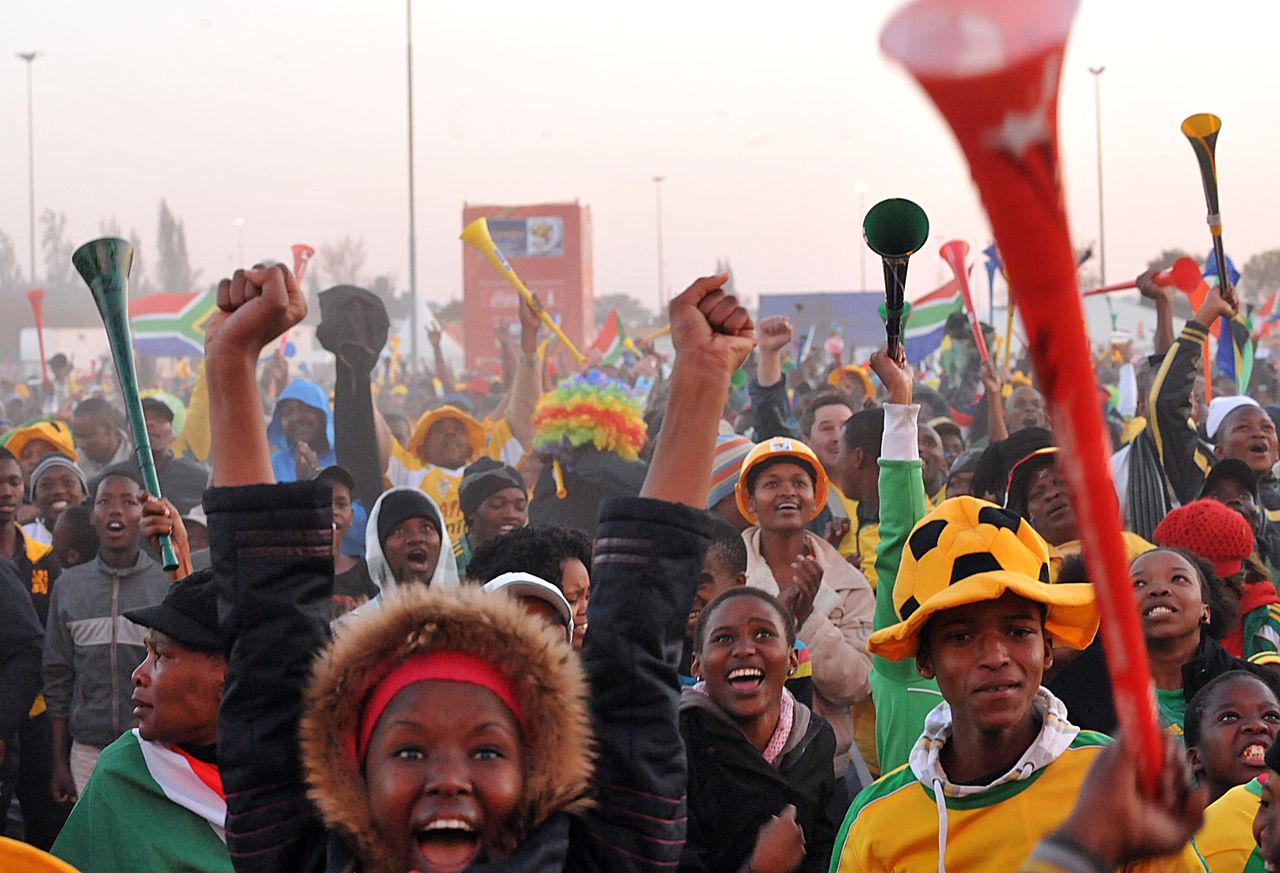 Football fans watch a South Africa versus Mexico World Cup opening match on a large outdoor screen in Soweto.