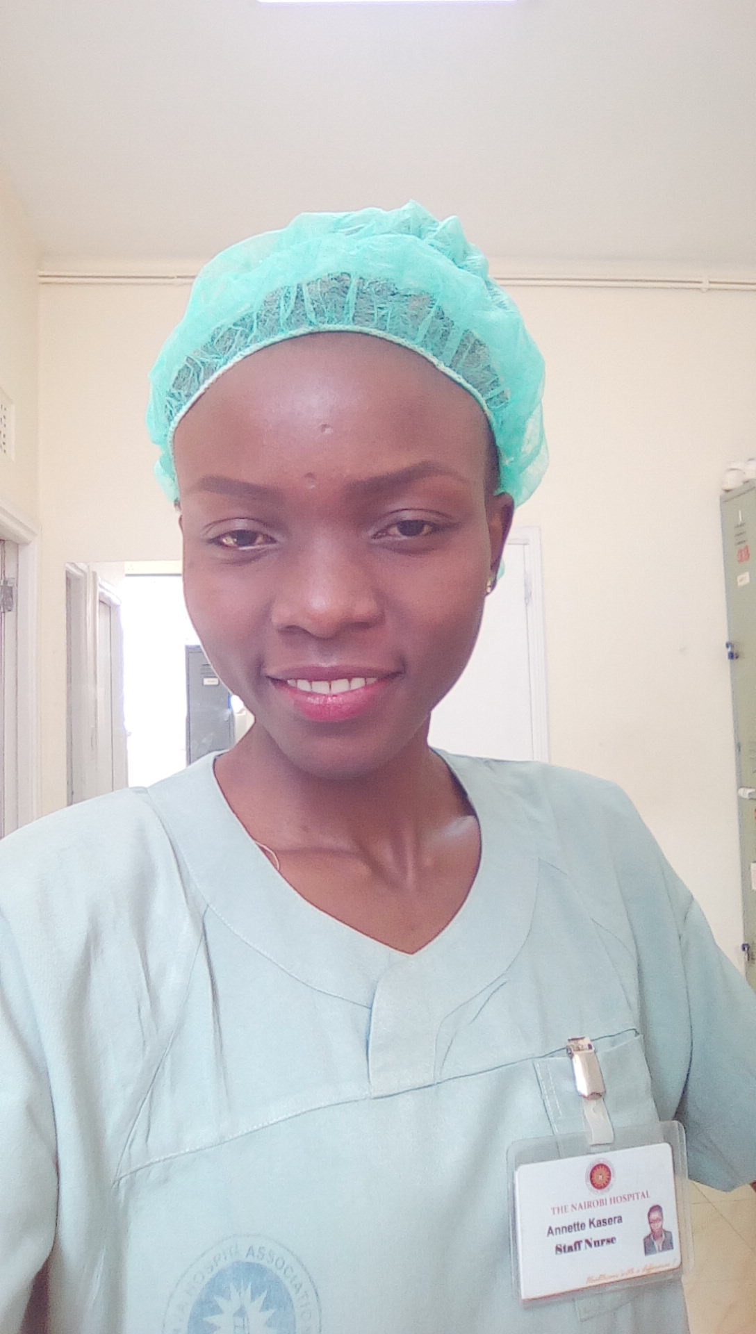 A nurse in surgical scrubs and cap working in an operating room at the Nairobi Hospital in Kenya.