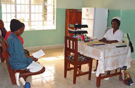 A nurse attends to patients on a hospital ward, illustrating the care work many trained Kenyans pursue abroad.