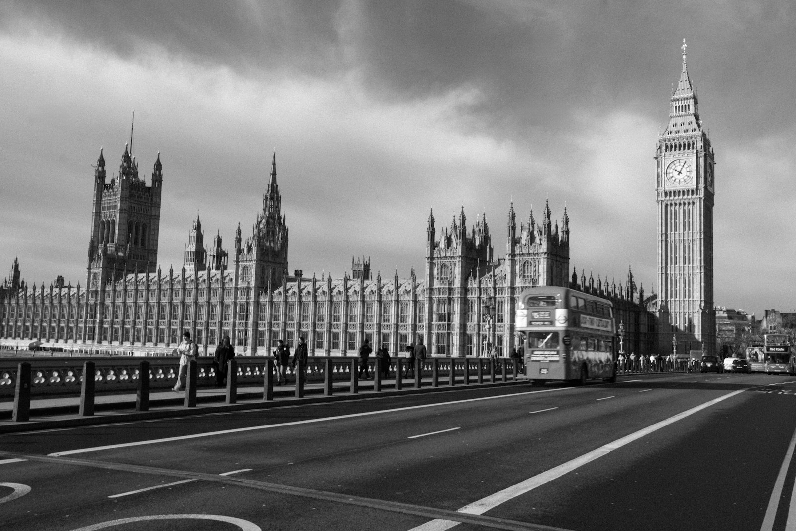 The Houses of Parliament and Big Ben in central London viewed across the Thames under a bright sky.